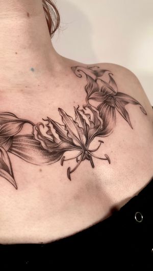 Explore the delicate beauty of this black and gray illustrative orchid tattoo by the talented artist Sam.