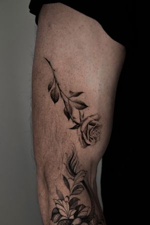 Get a stunning black and gray micro realism rose tattoo by artist Viola. Perfect for lovers of intricate floral designs.