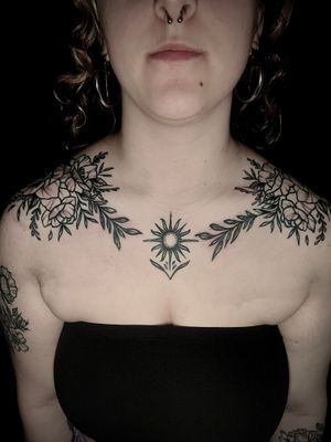 Unique ornamental and illustrative design featuring intricate flowers, branches, and vines, expertly crafted by tattoo artist Ben Twentyman.