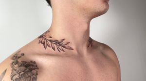Capture the beauty of nature with this black and gray olive branch tattoo, expertly crafted by Sam.