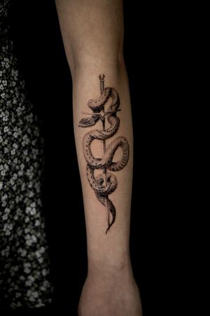 Incredible black and gray micro realism snake and sword tattoo by Viola.