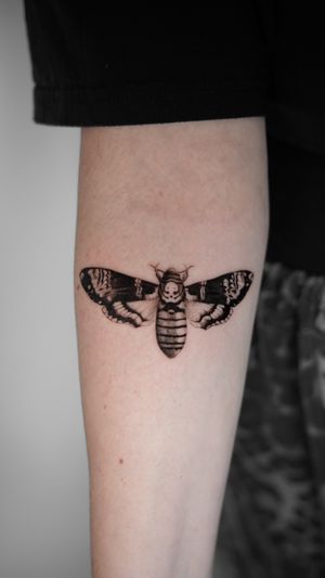 Stunning black and gray micro-realism tattoo of a moth symbolizing life and death, expertly done by Viola.