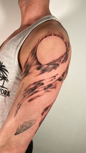 Get a bold blackwork tattoo of a sun and brush motif created by Sam, bringing uniqueness to your tattoo collection.