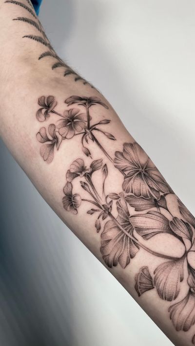 Get a stunning black and gray flower tattoo by the talented artist Sam. Perfect for a timeless and elegant piece of art on your skin.