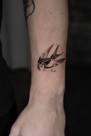 Elegant black and gray illustrative tattoo of a swallow bird and rose, beautifully created by Viola.