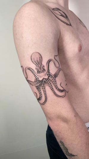 Get a stunning black and gray octopus tattoo done by the talented artist Sam. Embrace the intricate details of this mysterious sea creature.