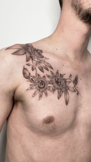 Beautiful black and gray botanical tattoo by Sam, featuring a detailed passion flower design.