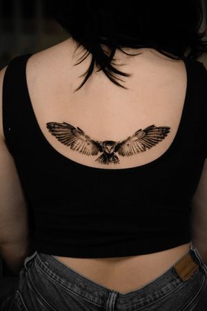 Experience the detailed beauty of a black and gray micro realism owl tattoo by the talented artist Viola.