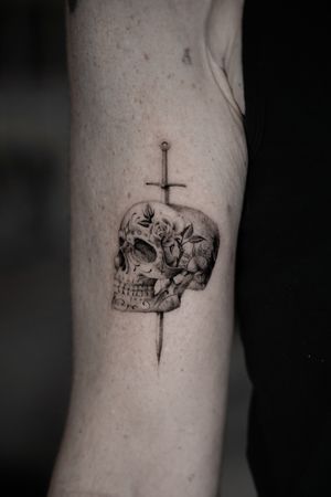 Incredible black and gray tattoo featuring a detailed skull, sugarskull, and sword design by the talented artist Viola.