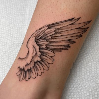 Fineline angel wing tattoo