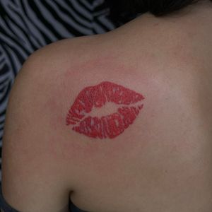 Get a bold and romantic tattoo showcasing lips, lipstick, and a kiss by the talented artist Zanzi La Vey. Perfect for expressing your love and passion.