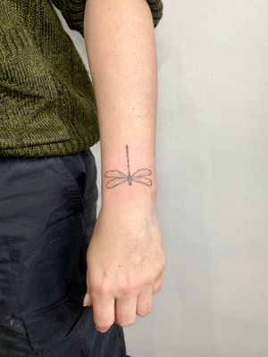Experience the delicate beauty of a hand-poked dragonfly tattoo by the talented artist Charlotte Pokes. Simply stunning!