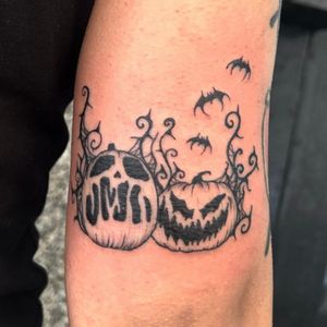 Get a unique blackwork pumpkin head tattoo with intricate illustrations by the talented artist Zanzi La Vey. Perfect for Halloween lovers!