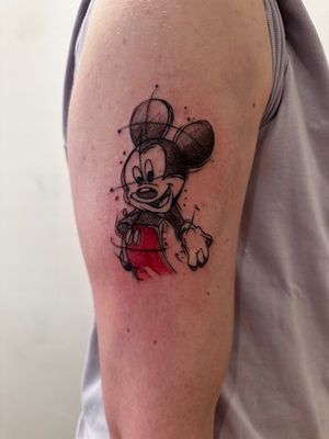 Get a whimsical and playful Disney sketch style tattoo of Mickey Mouse by the talented artist Oliver Soames.