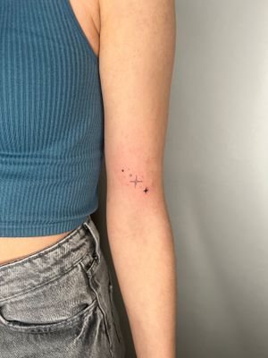 Elegantly created by Emma InkBaby, this dainty star tattoo features intricate fine line work.