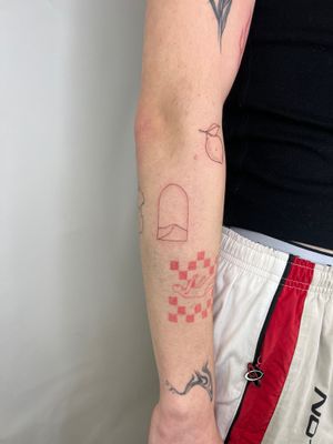 A beautiful fine line and illustrative tattoo of a window made of patchwork design, created by Emma InkBaby.