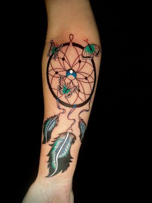 Capture the beauty of nature with this stunning tattoo by Ben Twentyman, featuring a butterfly, dreamcatcher, and feather motif.