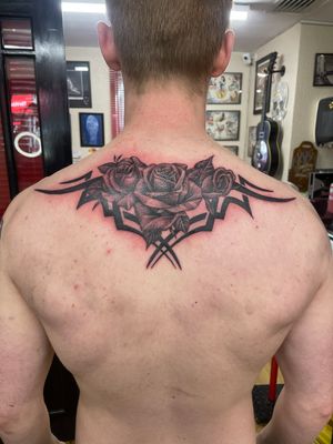 3 Roses in front of tribal wings