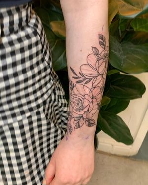 Admire the beauty of nature with this intricate floral tattoo by jadeshaw_tattoos. Perfect for those seeking a touch of elegance.