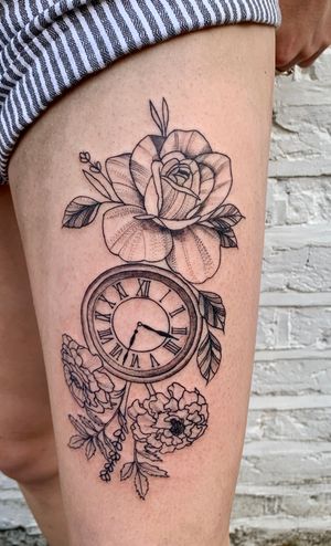 Elegant floral design intertwined with a vintage clock, expertly crafted by the talented artist, jadeshaw_tattoos.