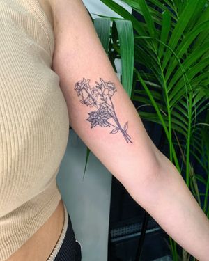 Admire the intricate details of this beautiful lily flower bundle tattoo by jadeshaw_tattoos. A stunning and timeless design.