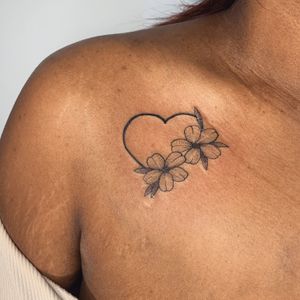 Check out this stunning tattoo by jadeshaw_tattoos, featuring a gorgeous flower and heart design on dark skin. Unique and eye-catching!