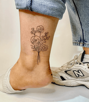 Elegant fine line tattoo featuring a beautiful bouquet of flowers by jadeshaw_tattoos. Perfect for those who love feminine and delicate designs.