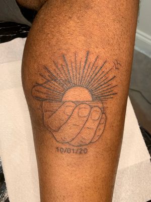 Illustrative tattoo of a sun on dark skin hand by jadeshaw_tattoos. Bright and bold design.