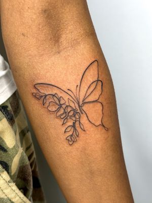 A stunning illustrative tattoo featuring a butterfly, flower, and abstract design in a single line style by jadeshaw_tattoos.