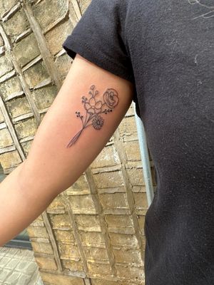 Check out this stunning fine line and illustrative tattoo of a flower bouquet by the talented artist jadeshaw_tattoos. Get inspired and book your session today!