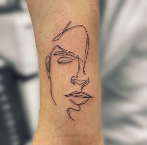 Admire the intricate simplicity of this fine line and illustrative single line face tattoo by talented artist jadeshaw_tattoos.