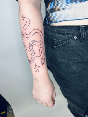 Illustrative tattoo of a snake coiled around a star, intricately designed by jadeshaw_tattoos.