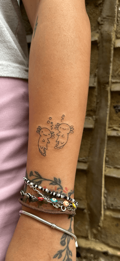 Adorable axolotl tattoo in a cute and illustrative style by jadeshaw_tattoos.