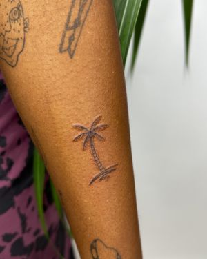 Escape to the beach with this illustrative tattoo by jadeshaw_tattoos. Detailed palm tree design in fine line style.
