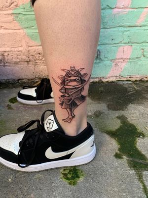 Get a unique illustrative tattoo of a frog with a samurai twist by jadeshaw_tattoos. Express your warrior spirit in a creative way!