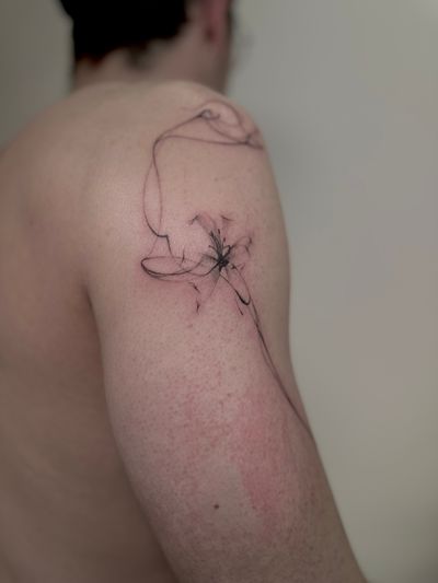 Saka Tattoo's illustrative design combines a beautiful flower with swirling smoke in an abstract style.