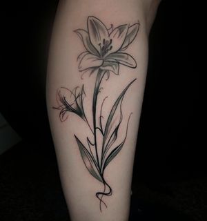 Get a stunning illustrative lily flower tattoo by Craig Hicks, blending abstract elements for a unique design.