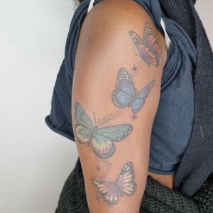 Get a beautiful illustrative tattoo of a vibrant butterfly, specially designed for dark skin tones by Belle Tannahill.