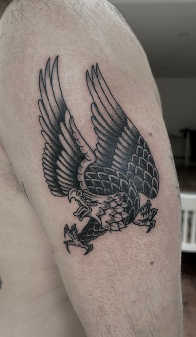 Fly high with this classic traditional eagle tattoo expertly crafted by artist Barney Coles. Bold lines and vibrant colors bring this majestic bird to life.
