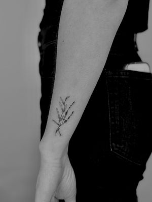 Capture the beauty of nature with this fine line lavender tattoo by Ruth Hall. Perfect for those who love floral designs.