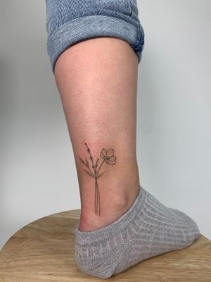 Beautifully intricate dotwork and fine line tattoo of a flower bouquet, created by the talented artist Chloe Hartland.