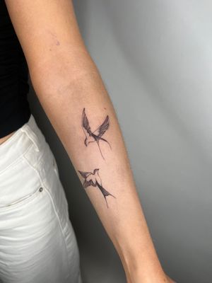 Get inked by Emma InkBaby with a stunning illustrative swallow bird design for a timeless and traditional tattoo.