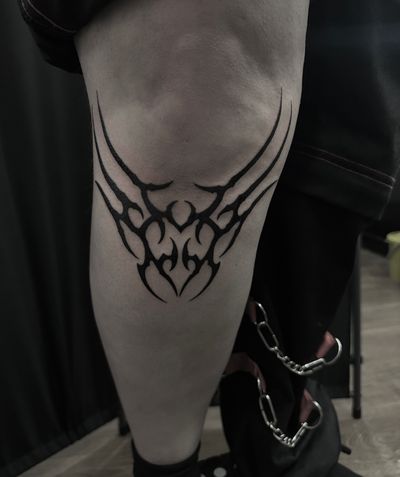Explore the fusion of cyber sigilism and tribal patterns in this striking blackwork tattoo of a heart, by the talented artist Sophia Hayes.