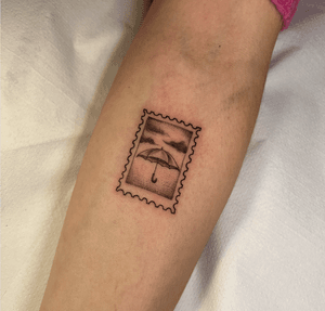 Illustrative tattoo featuring a post, mail, stamp, and umbrella motif, designed by Cristina.