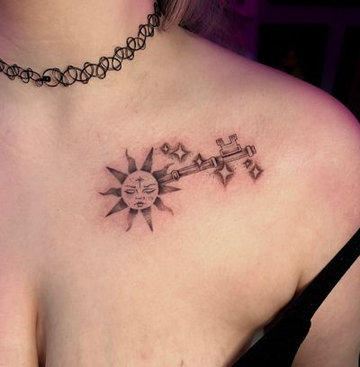 Unique dotwork style tattoo by Cristina, featuring a summer sun and key motif in black and gray illustrative design.