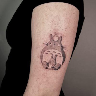 Capture the magic of Studio Ghibli with a charming Totoro tattoo by artist Cristina. An adorable anime design sure to bring joy and nostalgia.