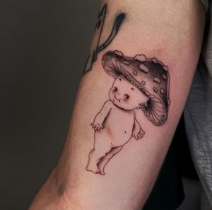 Illustrative tattoo by Cristina featuring a cute baby and mushroom motif, perfect for those who love whimsical designs.