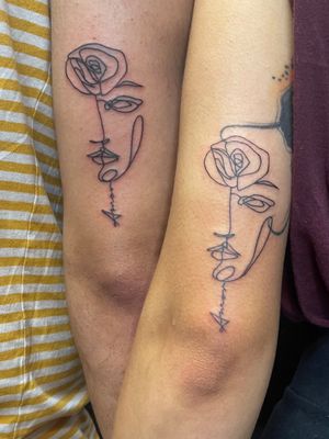 Matching tattoo for a cute couple, this is both my clients faces mixed together which doubles up as a stemmed rose with the word Amor in the neck 