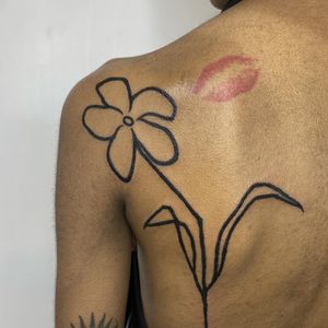 Bold blackwork style flower tattoo by the talented artist Charlie Macarthur, showcasing a unique and edgy design.