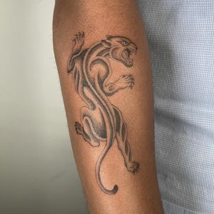 Get a bold and timeless traditional panther tattoo by skilled artist Charlie Macarthur.